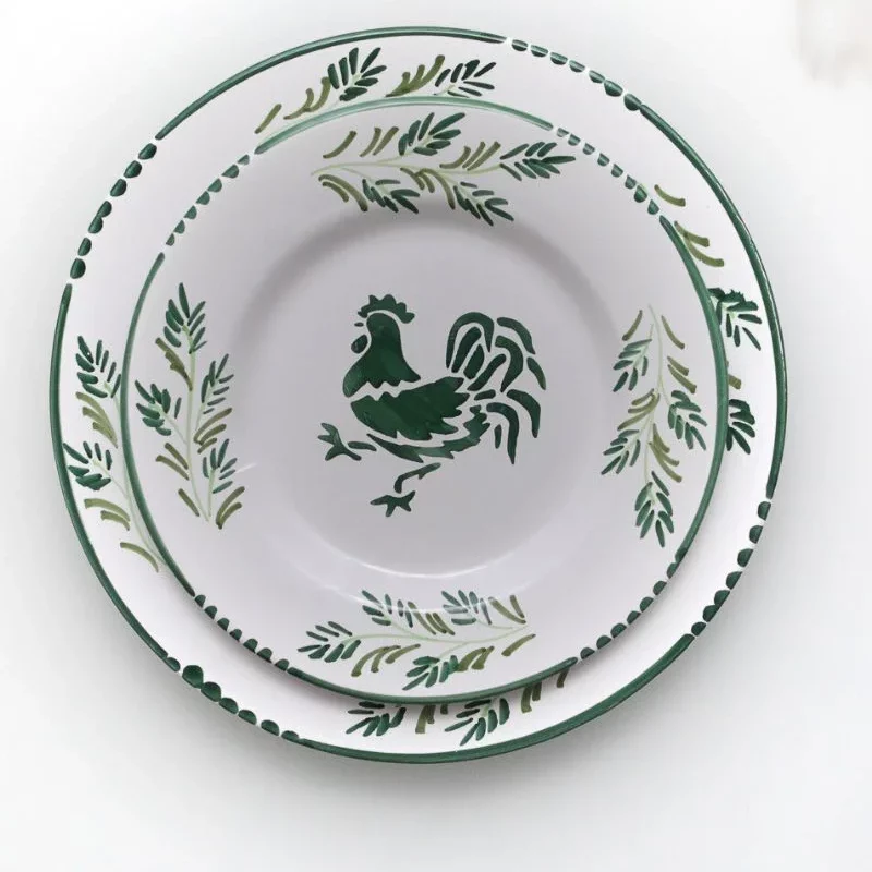 Assiette plate en majolique de la collection Coq, peinte à la main avec des motifs traditionnels, posée sur une table