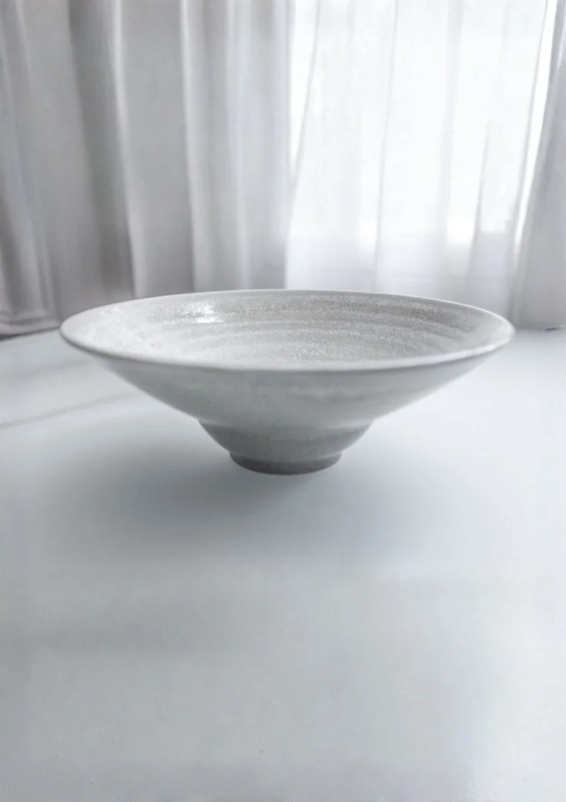Assiette en grès artisanale Venus dressée sur une table élégante